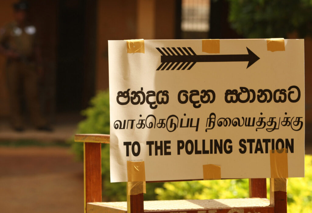 JAFFNA, SRI LANKA - SEPTEMBER 21:  A sign directing voters to the polling station during the northern provincial council election on September 21, 2013 in Jaffna, Sri Lanka. Ethnic Tamil voters in Sri Lanka's war-ravaged north have gone to the polls on Saturday to form their first functioning provincial government since 1988 following 26-year long civil war that ended in the country in 2009..  (Photo by Buddhika Weerasinghe/Getty Images)